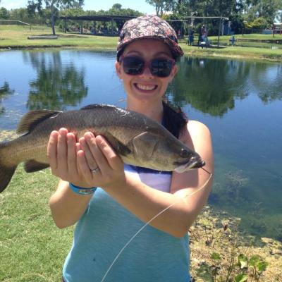 girl holding a huge barramundi fish