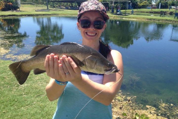 girl holding a huge barramundi fish