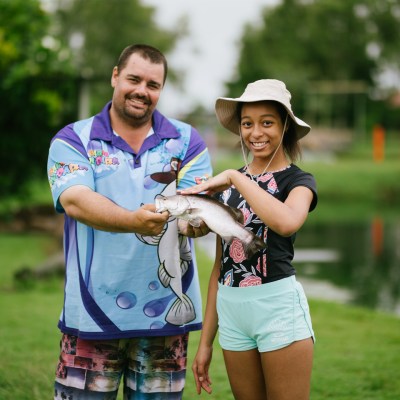 father and son holding a fish