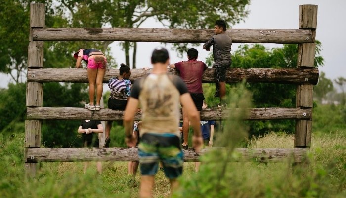 a girl sitting on a bench in a park