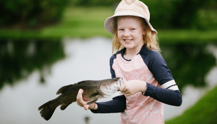 a woman holding a fish