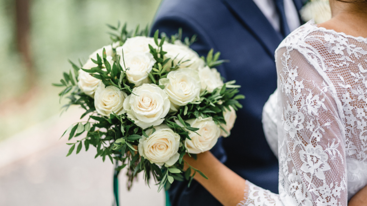 a close up of a person holding a flower