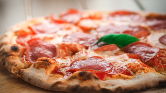 a close up of a slice of pepperoni pizza on a tray