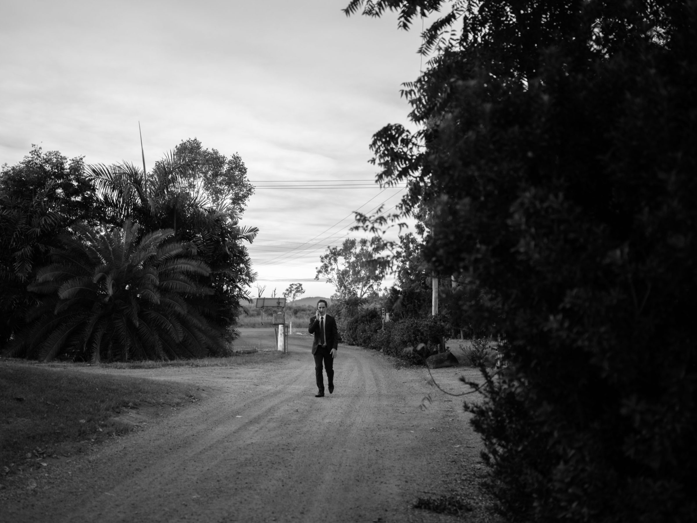 a man riding a bike down a dirt road