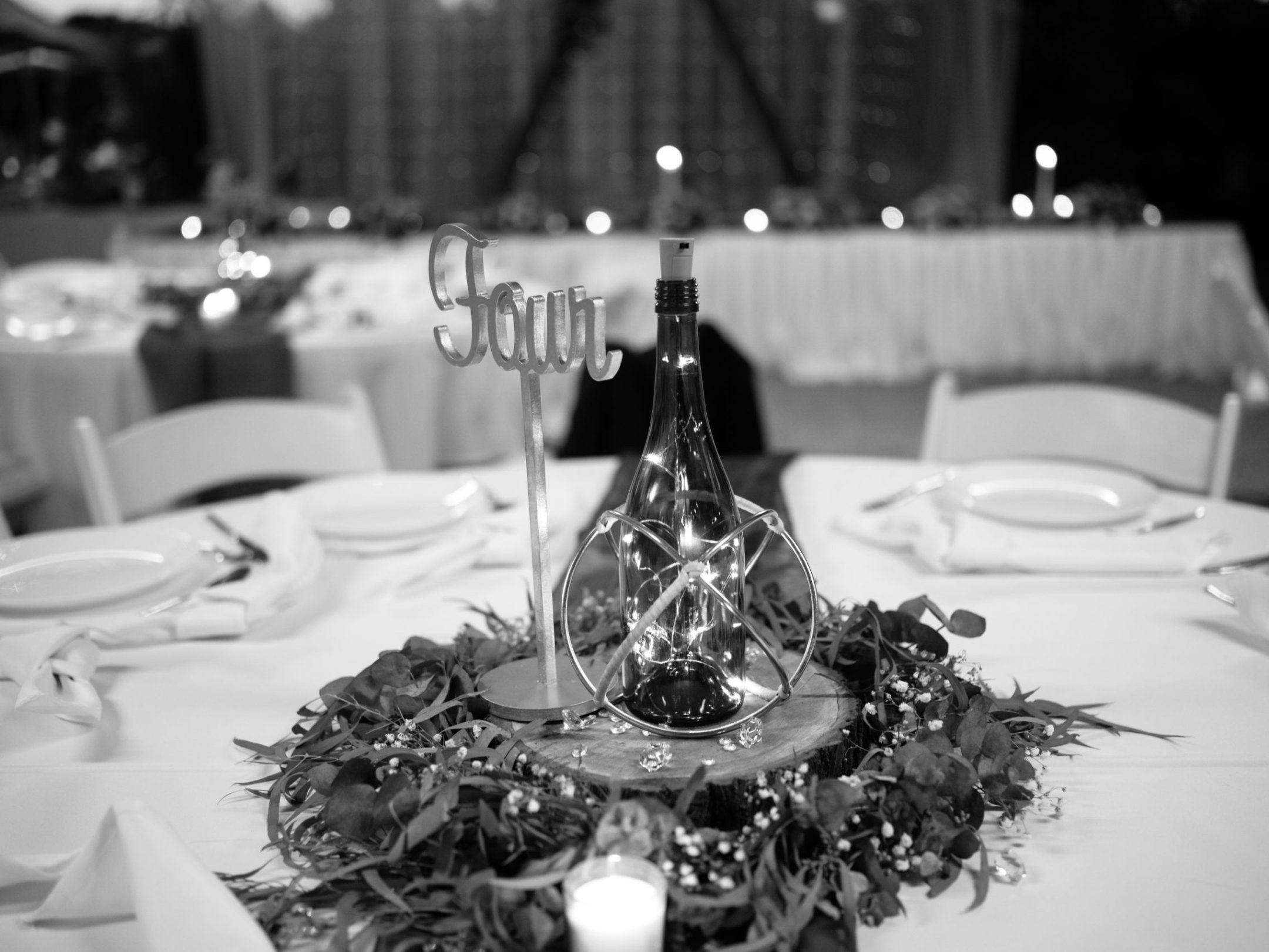 a person sitting at a table with wine glasses